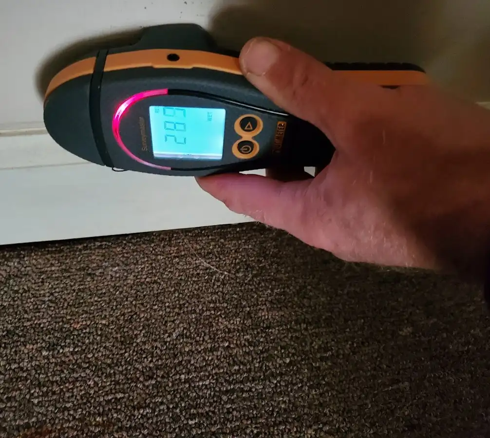 Moisture detection at baseboard during Storm Damage Restoration in Baytown